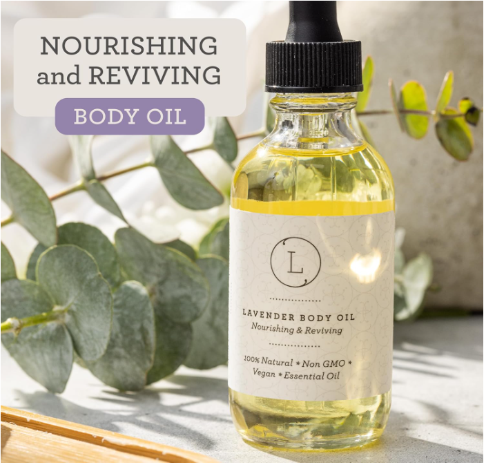 Bottle of lavender body oil with eucalyptus leaves in the background