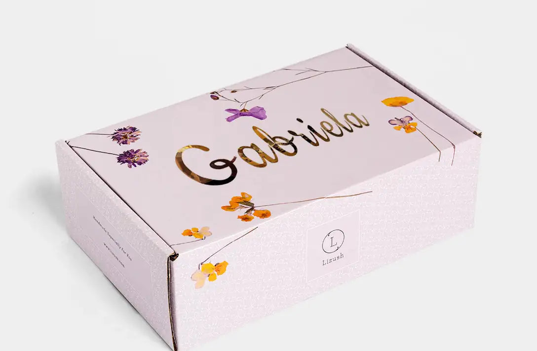 Box with 'Gabriela' branding and floral designs on a white background