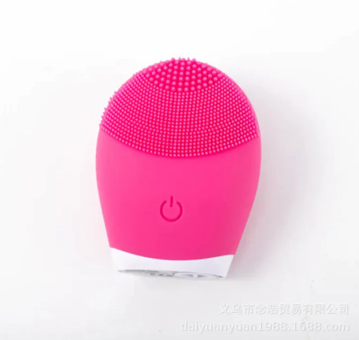 Pink facial cleansing brush with power symbol on a white background