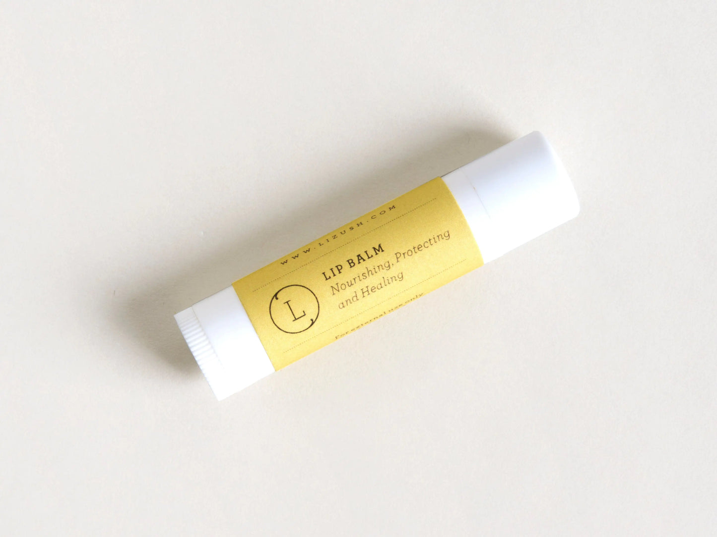Lip balm with a yellow label on a white background