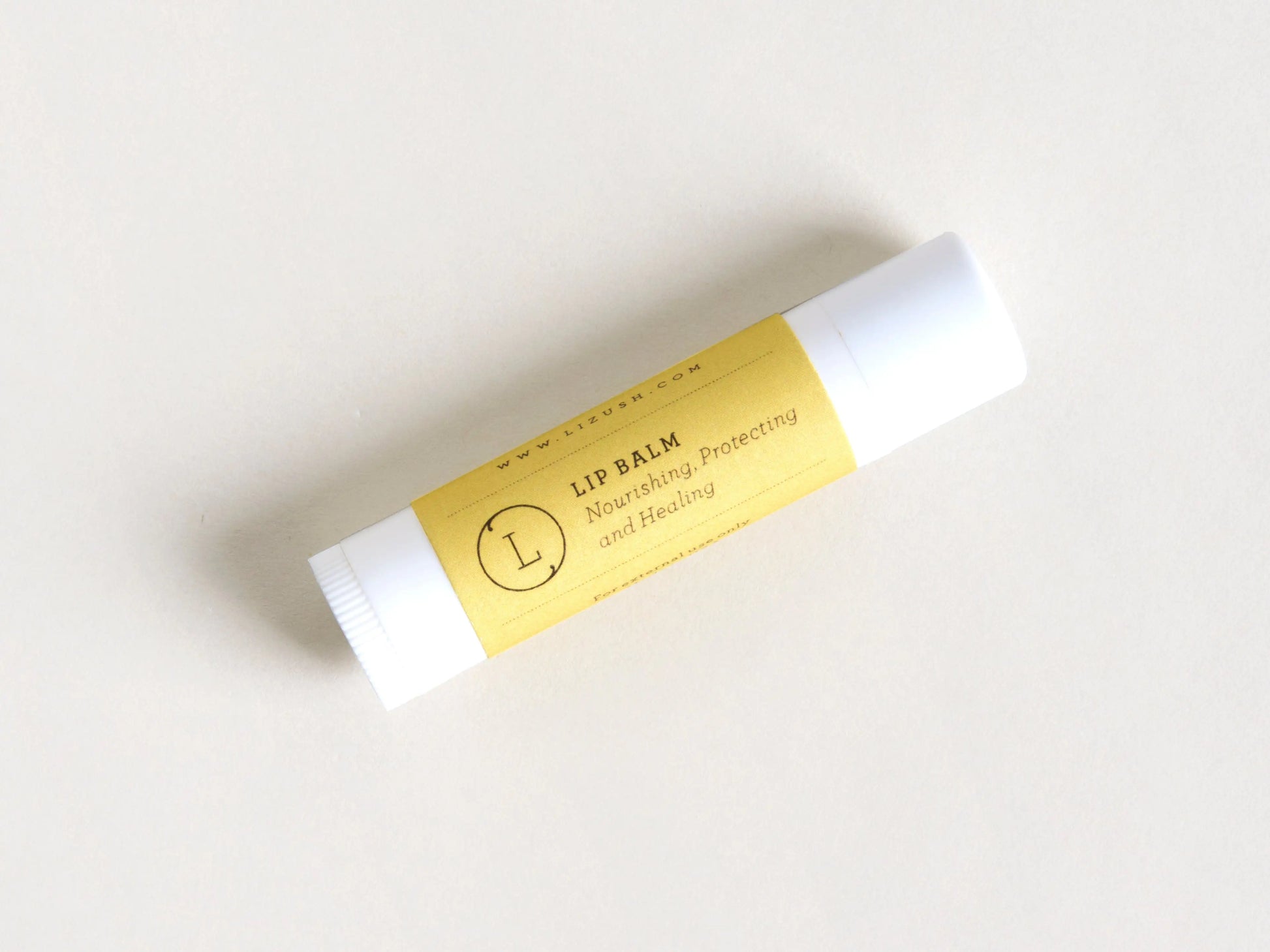 Lip balm with a yellow label on a white background